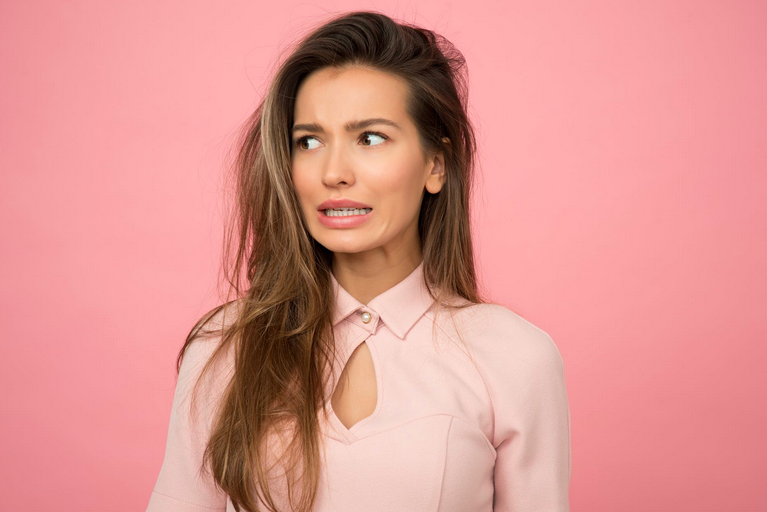 Woman looking nervous about privacy concerns from clearview
