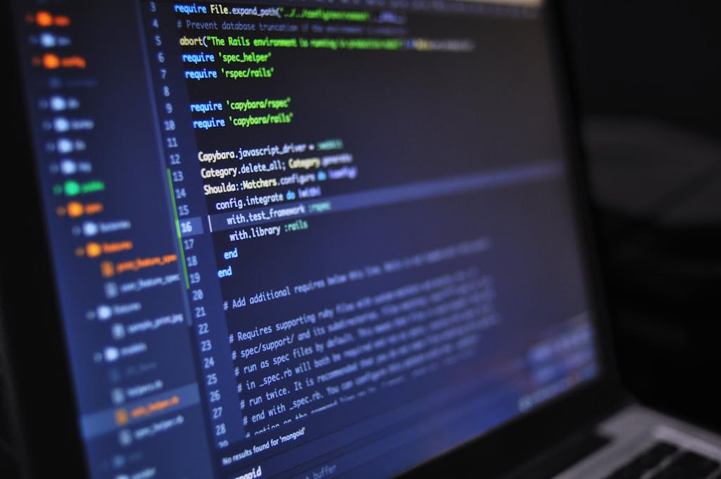 Computer screen displaying programming code in a dark environment for the cost of hiring. Net developers