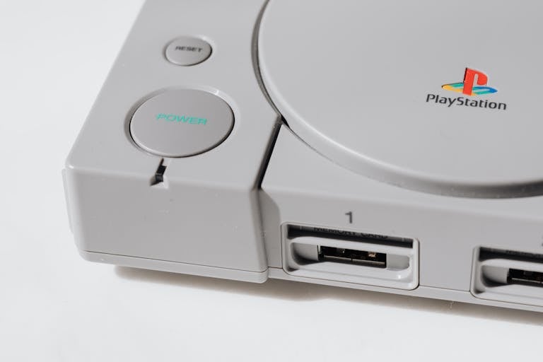 Close-up view of a classic playstation gaming console from the 90s, showcasing its iconic design.