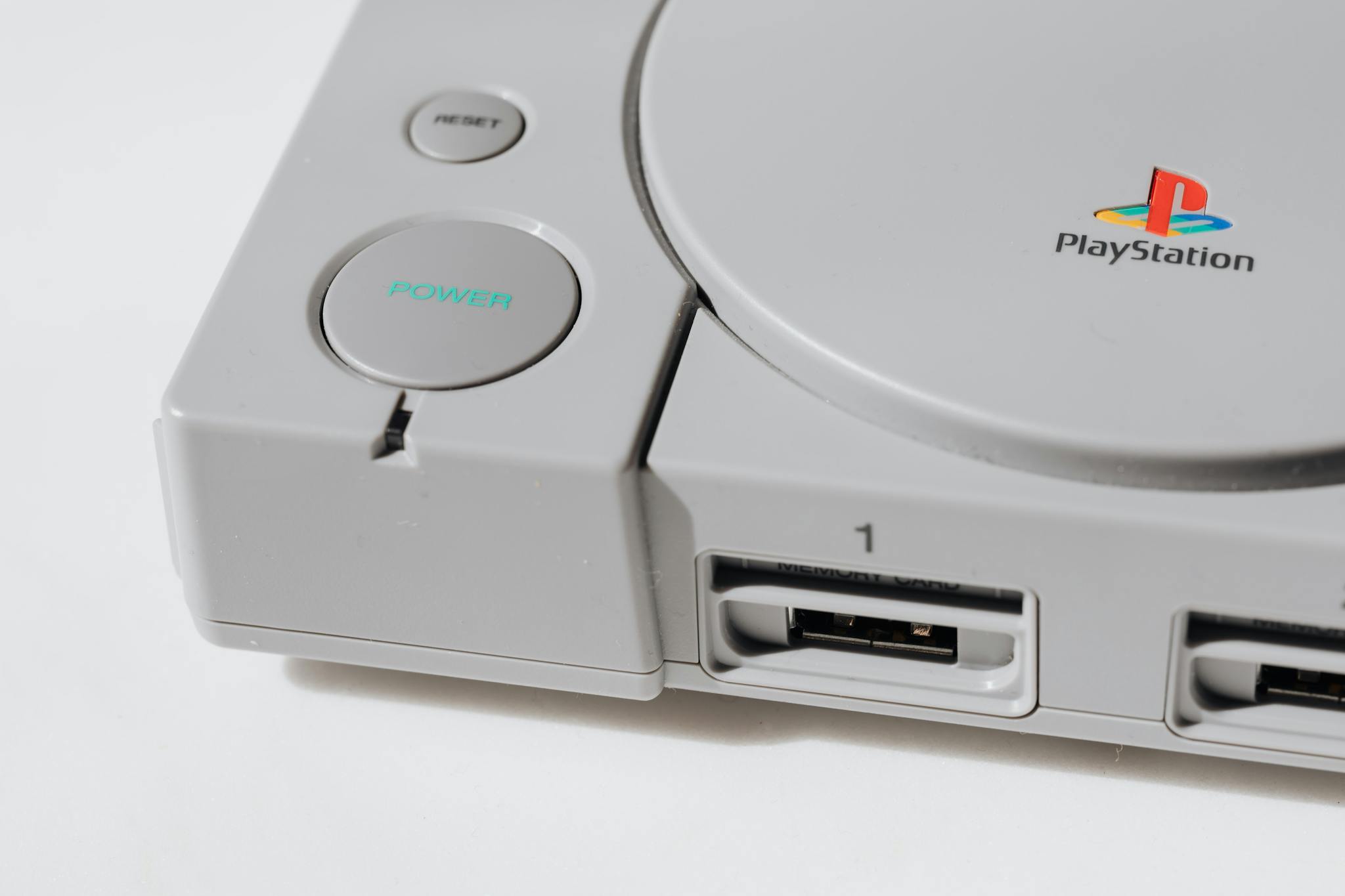 Close-up view of a classic playstation gaming console from the 90s, showcasing its iconic design.